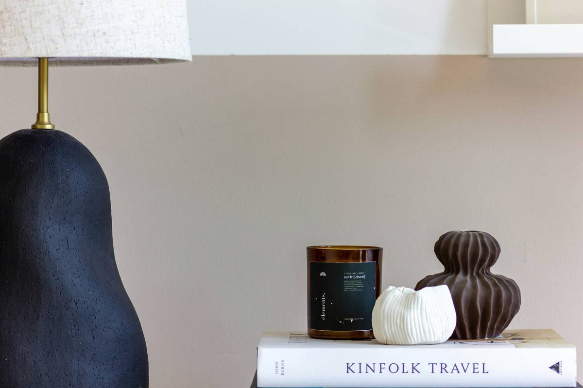 Infographic showing how decorative boxes improve visual balance in home styling—comparing cluttered vs. curated shelf arrangements with labeled principles: rhythm, scale, negative space